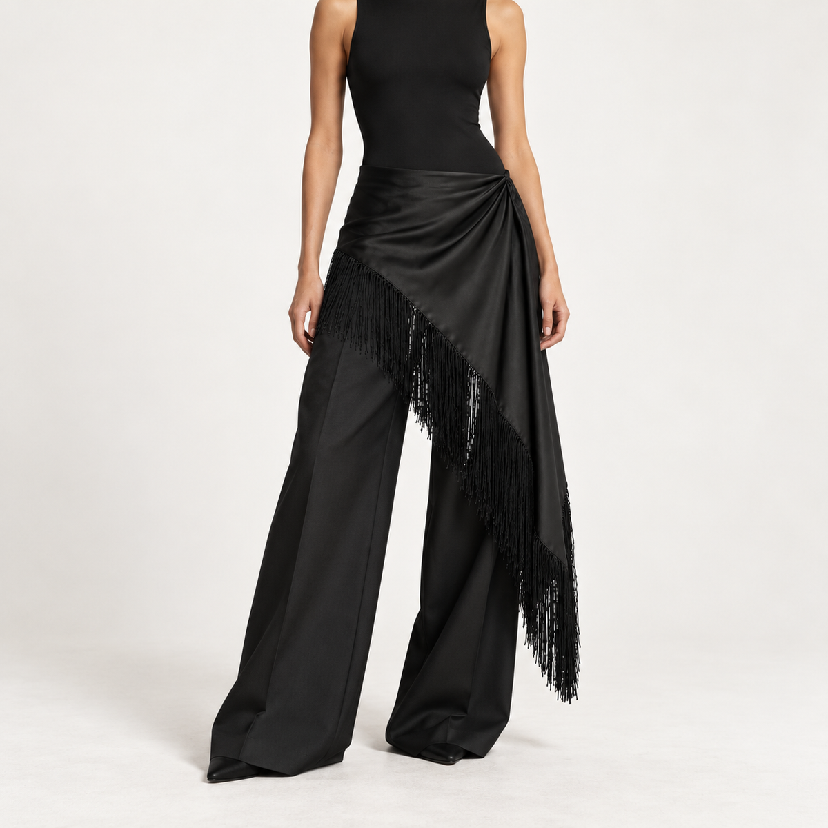 Asymmetric satin fringe wrap styled over low-rise wide-leg trousers
